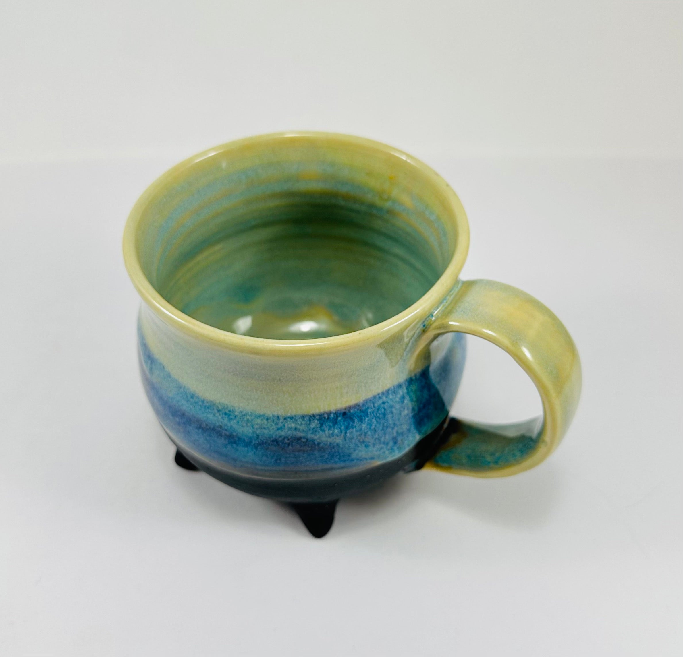 handmade cauldron mug in a beautiful green and blue glaze