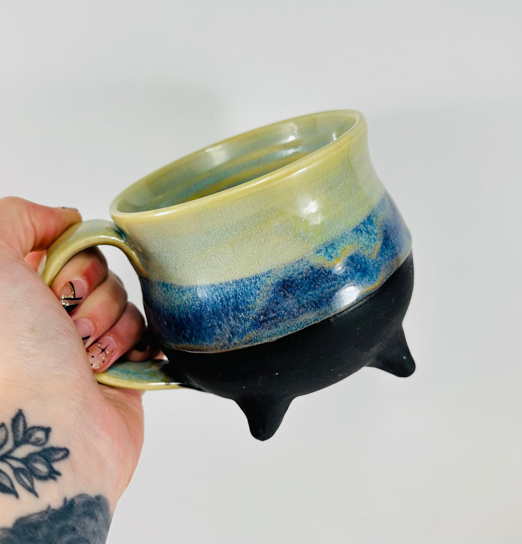 handmade cauldron mug in a beautiful green and blue glaze