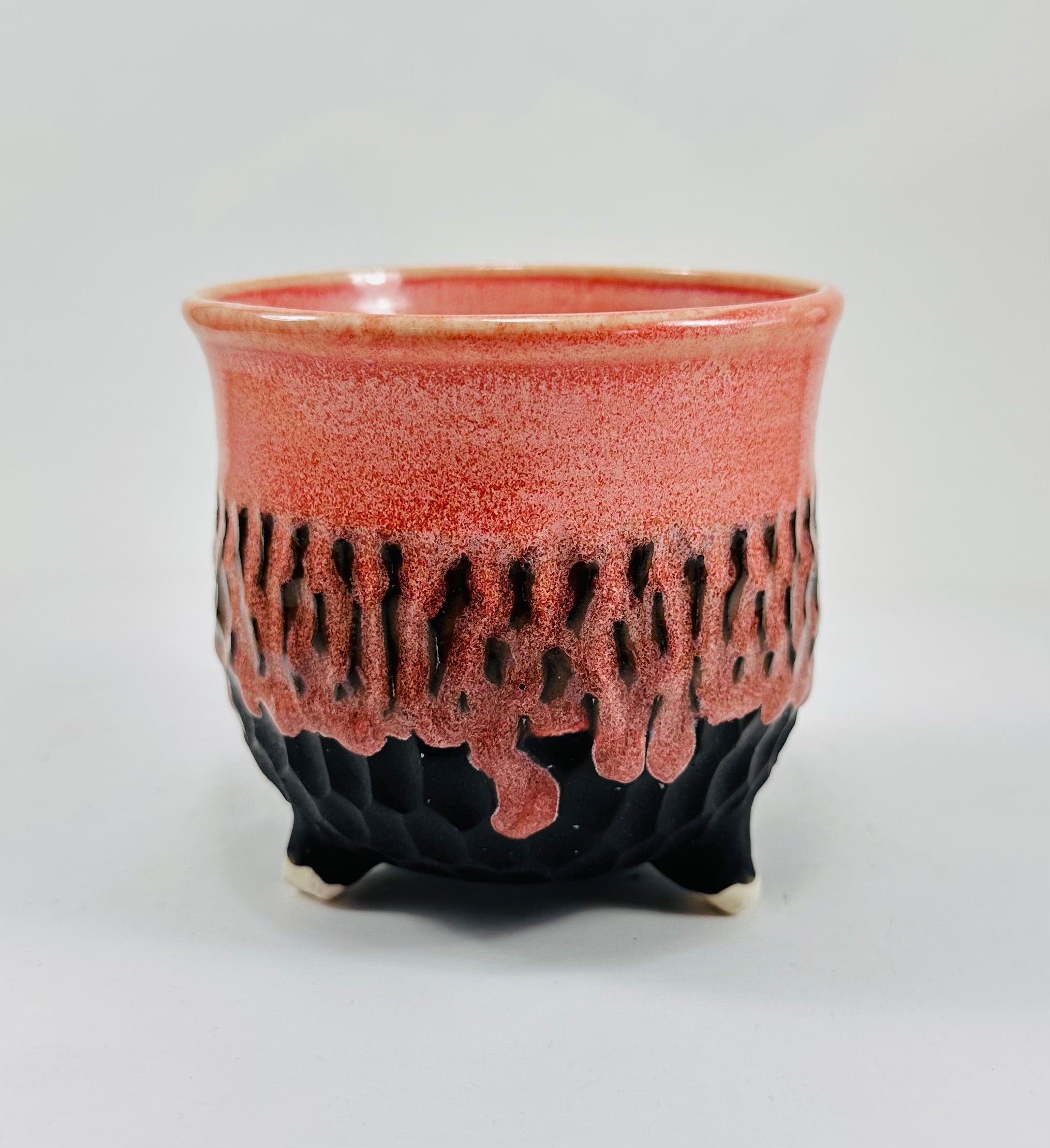 A handmade ceramic cauldron in a beautiful pink and black glaze