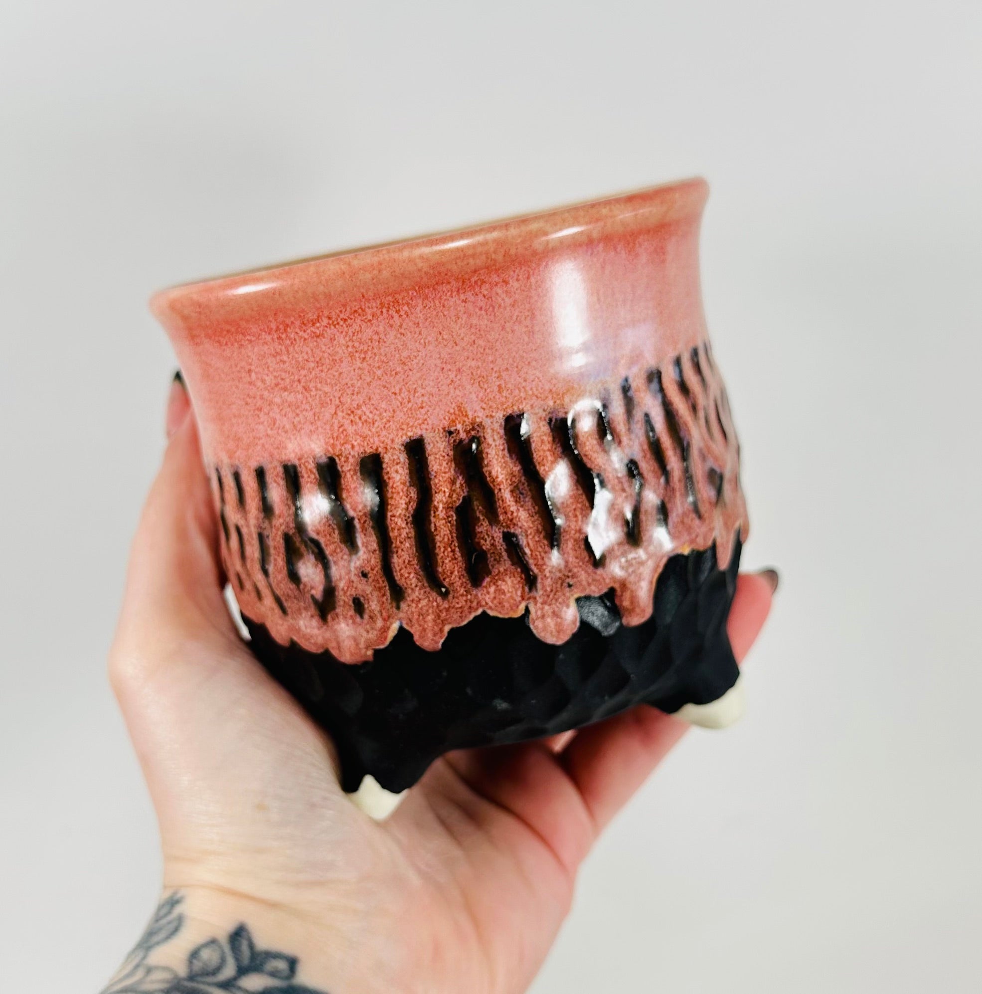 A handmade ceramic cauldron in a beautiful pink and black glaze