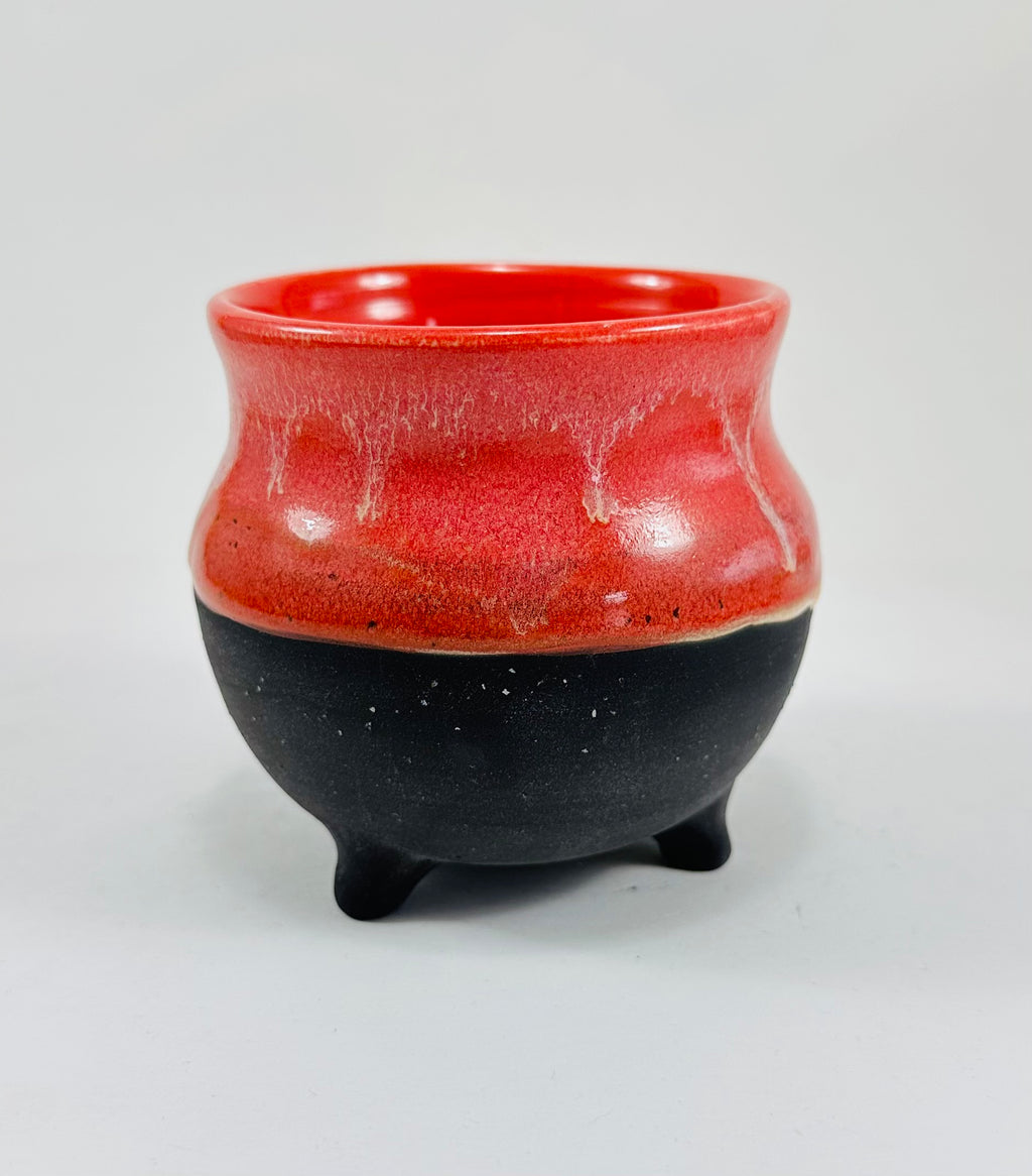 A handmade ceramic cauldron in a beautiful pink and black glaze