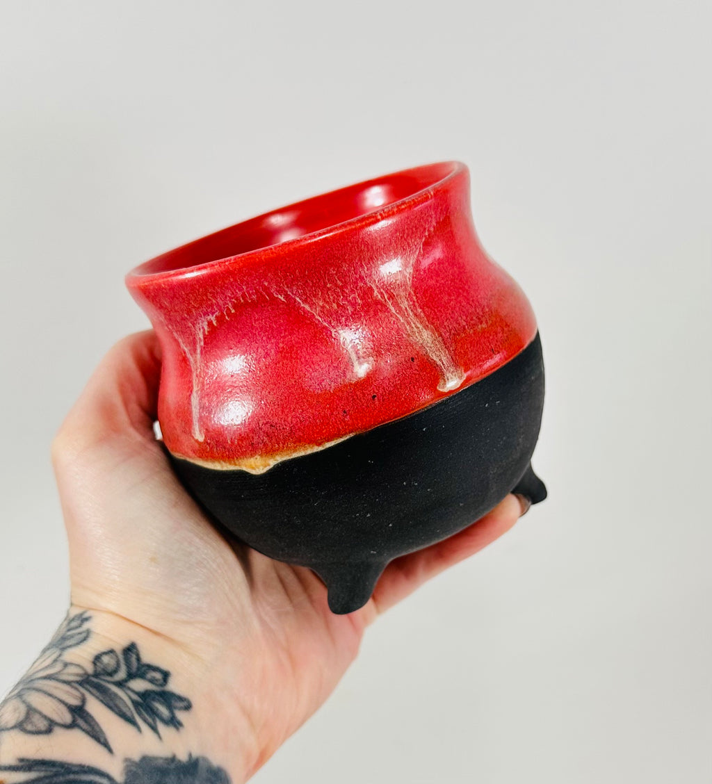 A handmade ceramic cauldron in a beautiful pink and black glaze