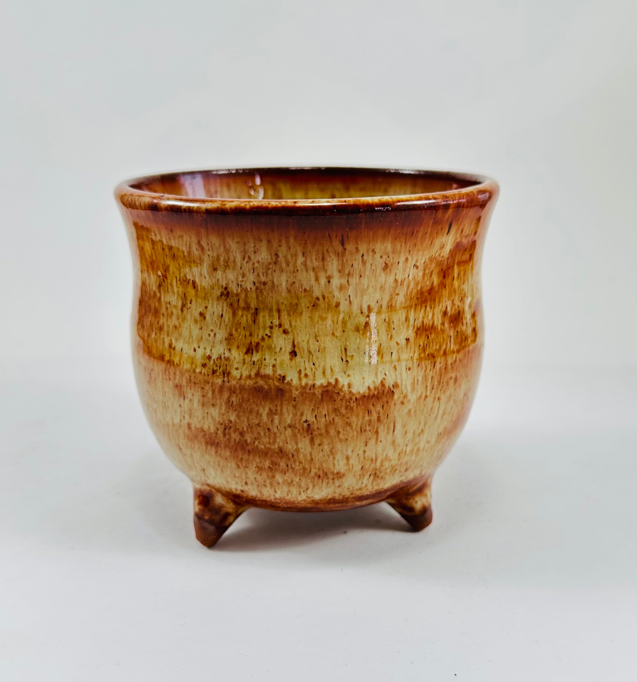 A handmade ceramic cauldron in a beautiful brown glaze