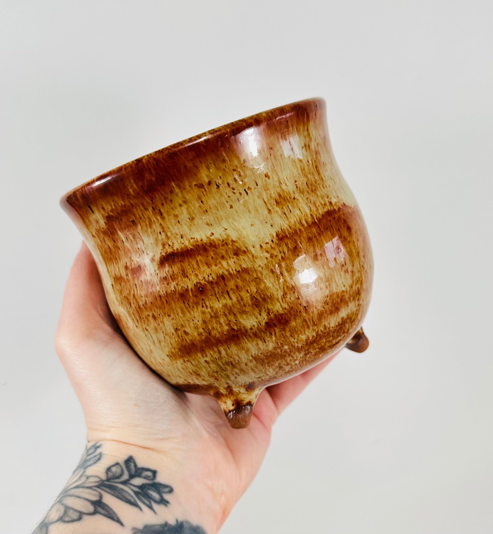 A handmade ceramic cauldron in a beautiful brown glaze