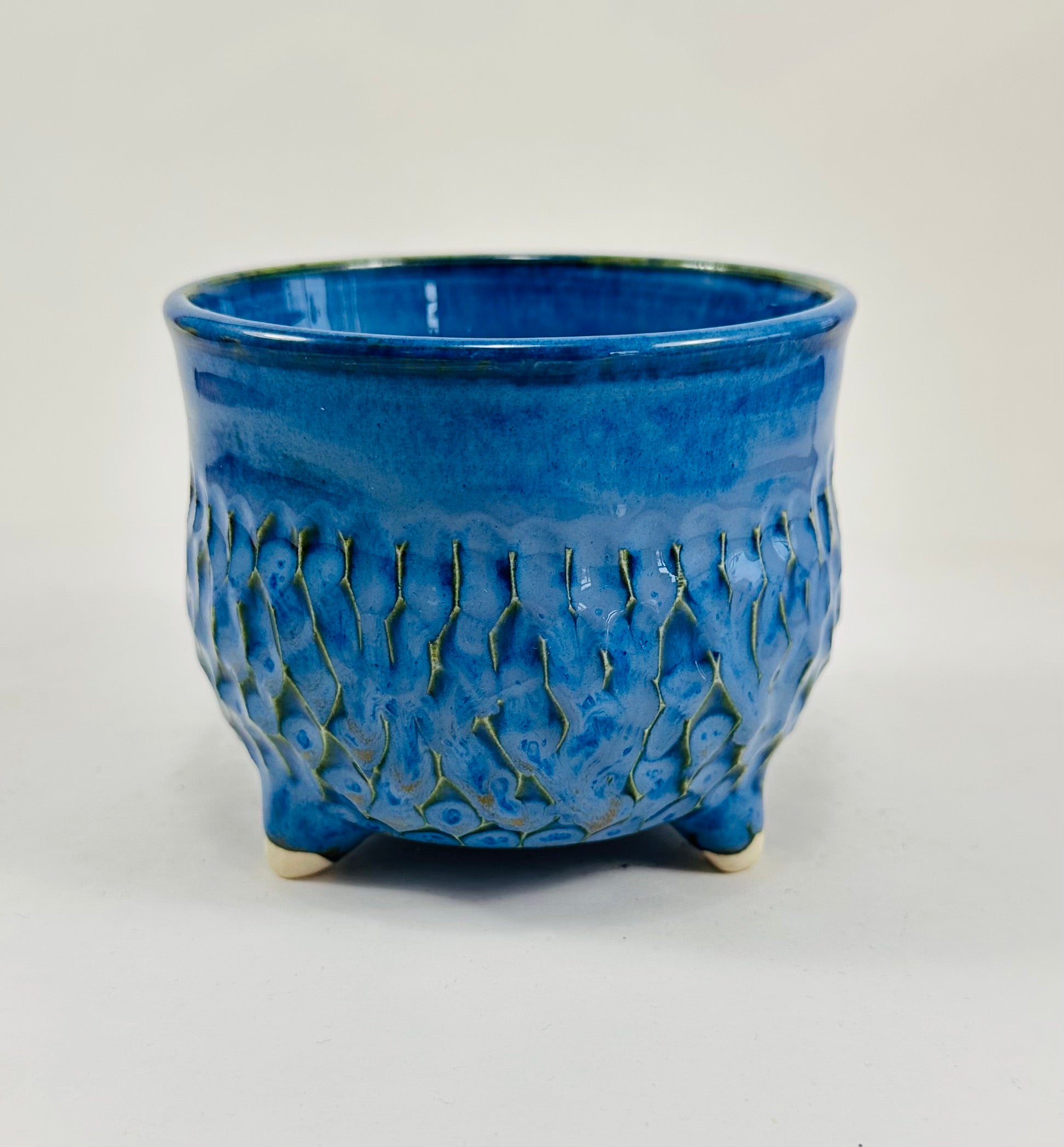 A handmade ceramic cauldron in a beautiful blue glaze