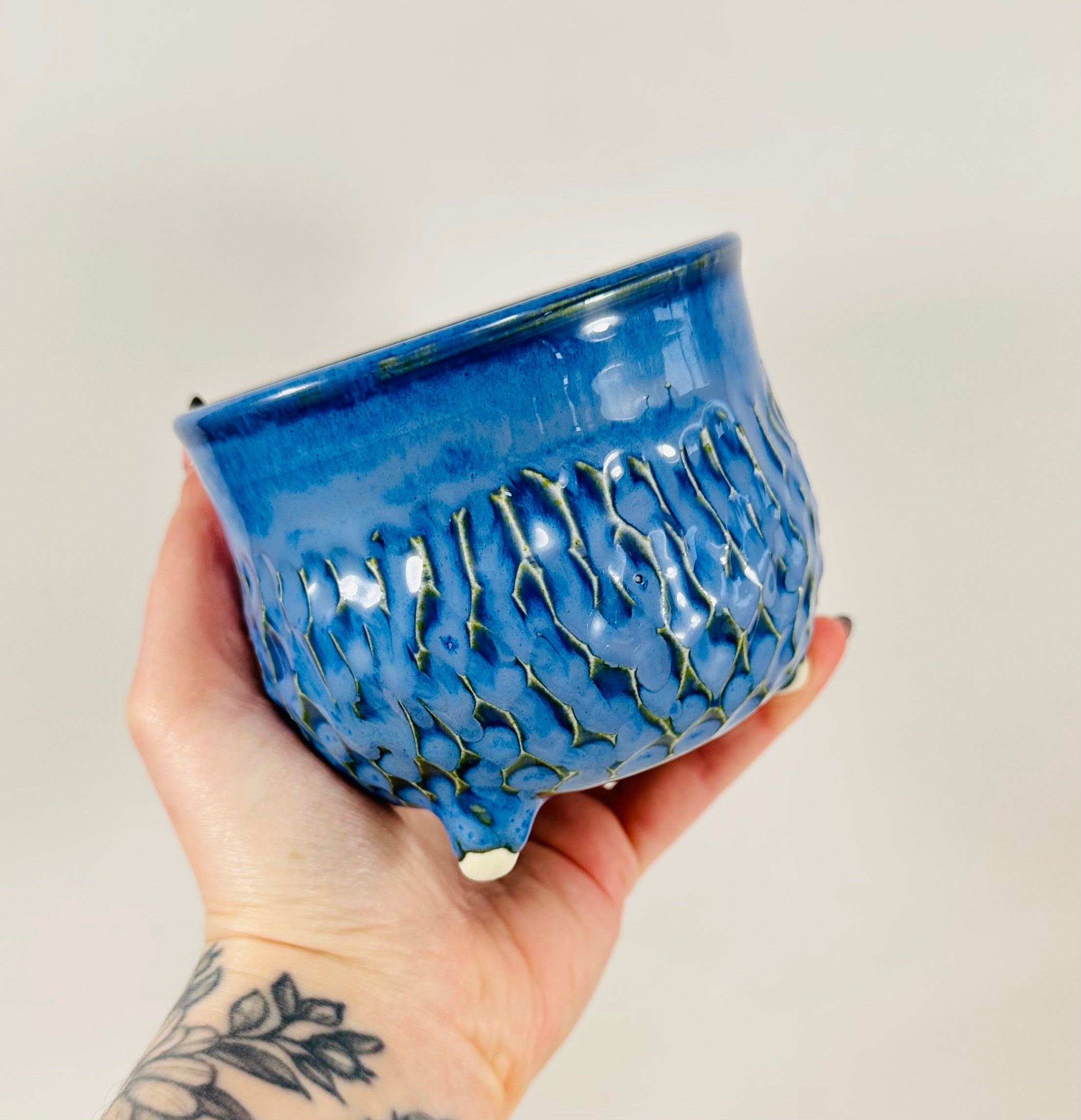 A handmade ceramic cauldron in a beautiful blue glaze