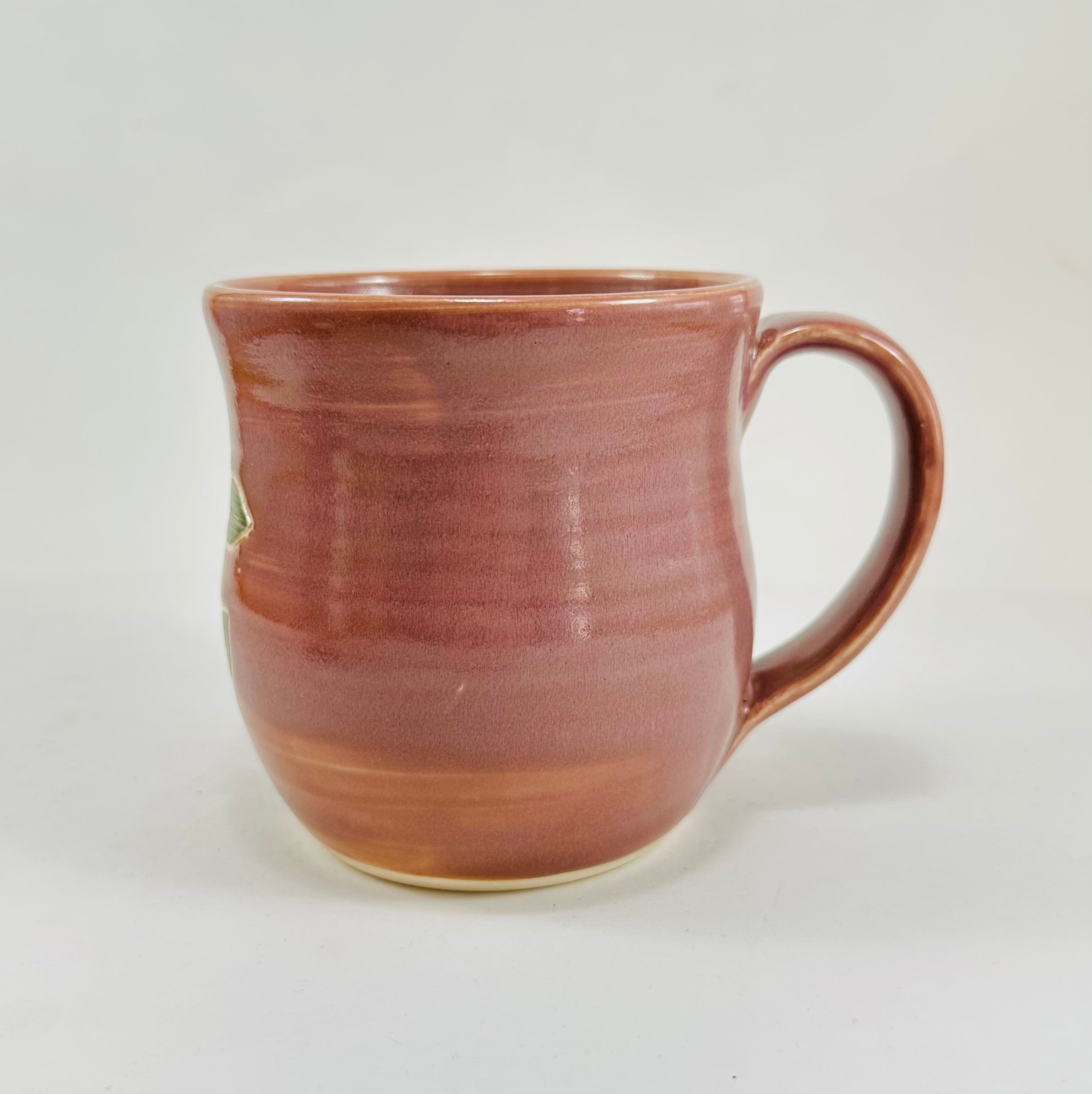 handmade ceramic mug in a beautiful lavender glaze and lady bugs illustrated on it.